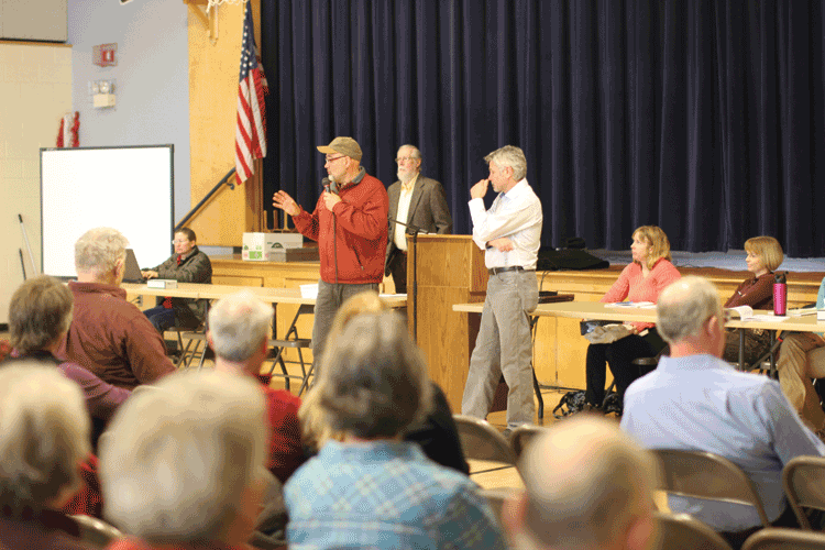 Mark Woodward addresses the assembly at the Johnson Town Meeting