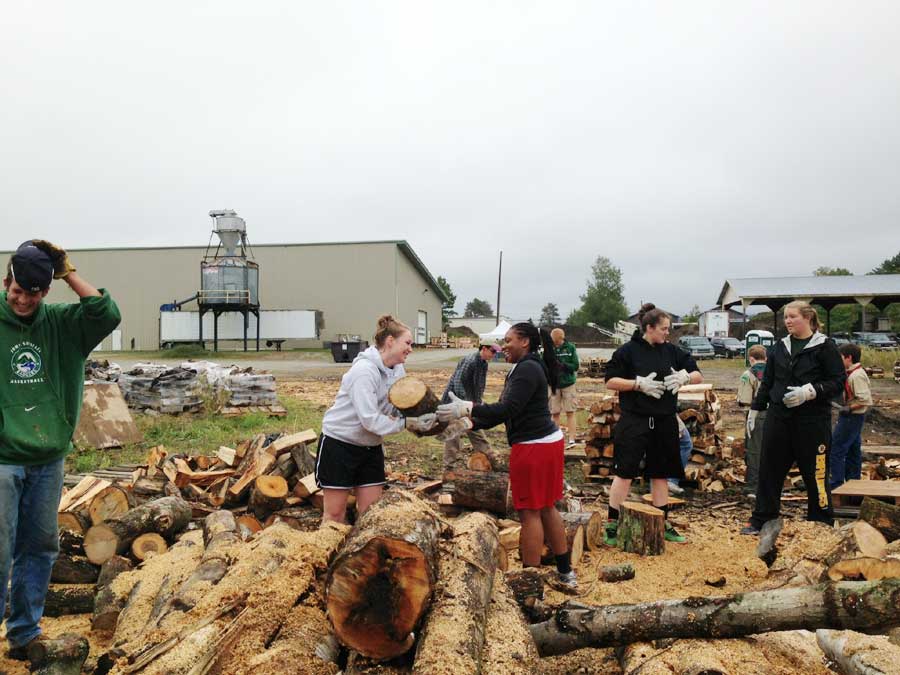 JSC and local community members move and stack wood for the United Way of Lamoille County Firewood Project as part of the college's "SERVE Local" program, which sponsors local service opportunities during the academic year.