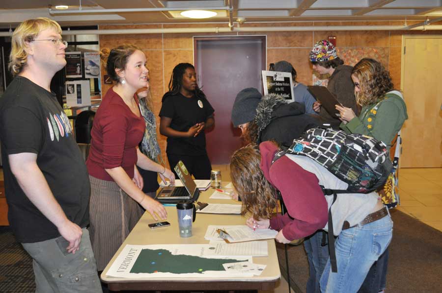 JSC students Ben Watson and Liz Beatty-Owens collected signatures for a petition in the Stearns Lobby. The petition alleges that Sodexo’s policy changes are illegal and unfair.(photo by Mariah Howland)