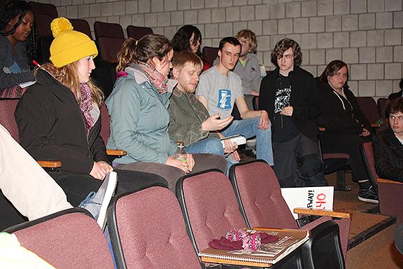 Student-trustee member Colin Santee shows a crowd of Johnson State College students  financial data on Vermont State Colleges Feb. 19.