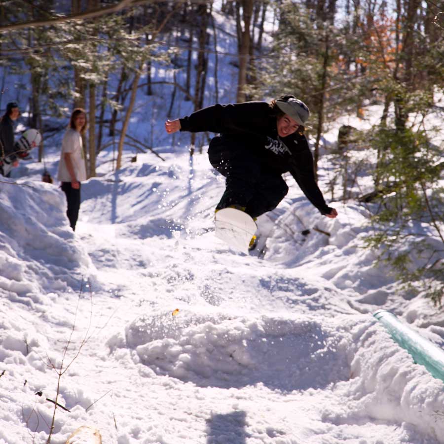 JSC Ski and Ride club members Lucas Peduzzi and Jake Eustis look on as Brandon Covert airs over the flat tube with a huge smile on his face.
