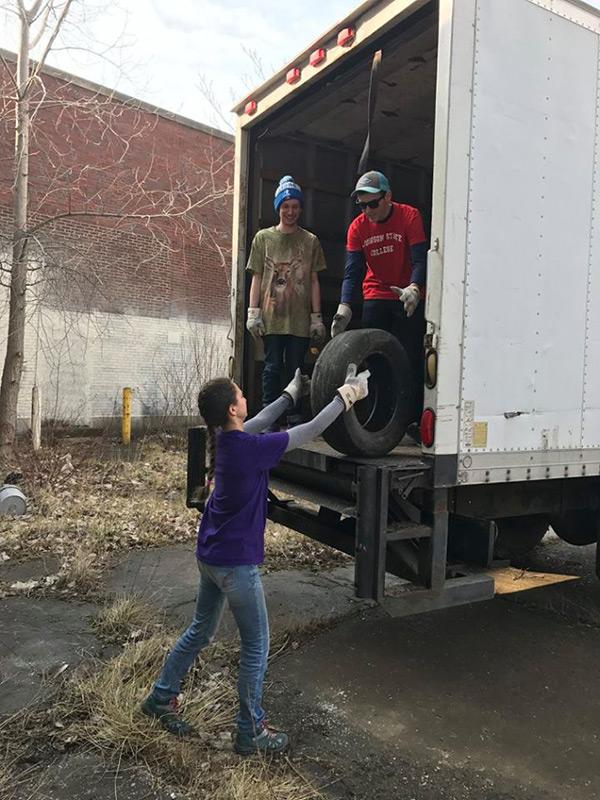 Zac Whitcomb, Seth Irwin and Sasha Yazdzik transport tires to be recycled