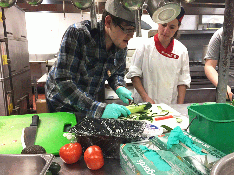 Thomas Streeter and Peggy Edwards peeling a cucumber at a Vegan Cooking Club meeting