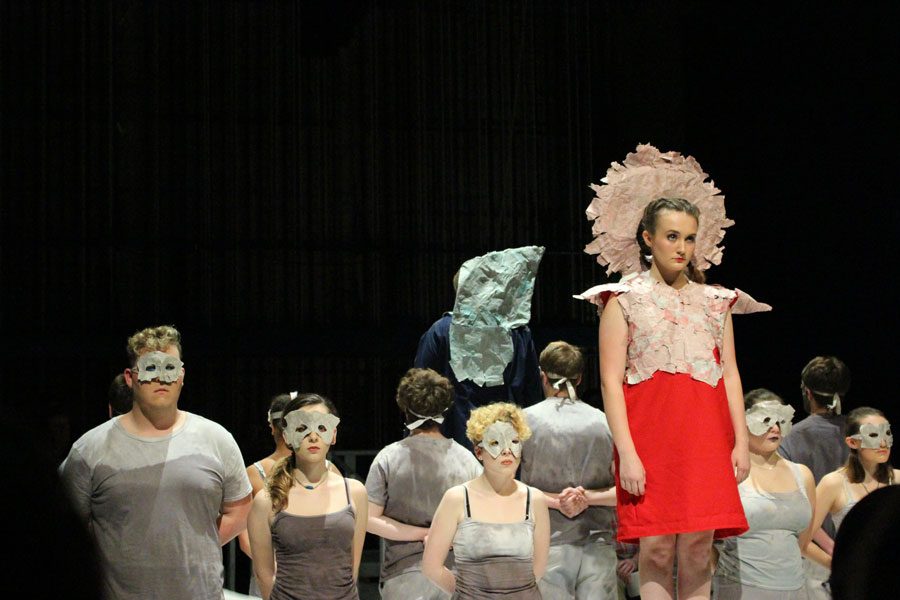 Katelyn Shaw as Antigone, with ensemble behind