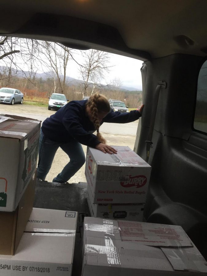 Mikayla Turner moves boxes of food                                    