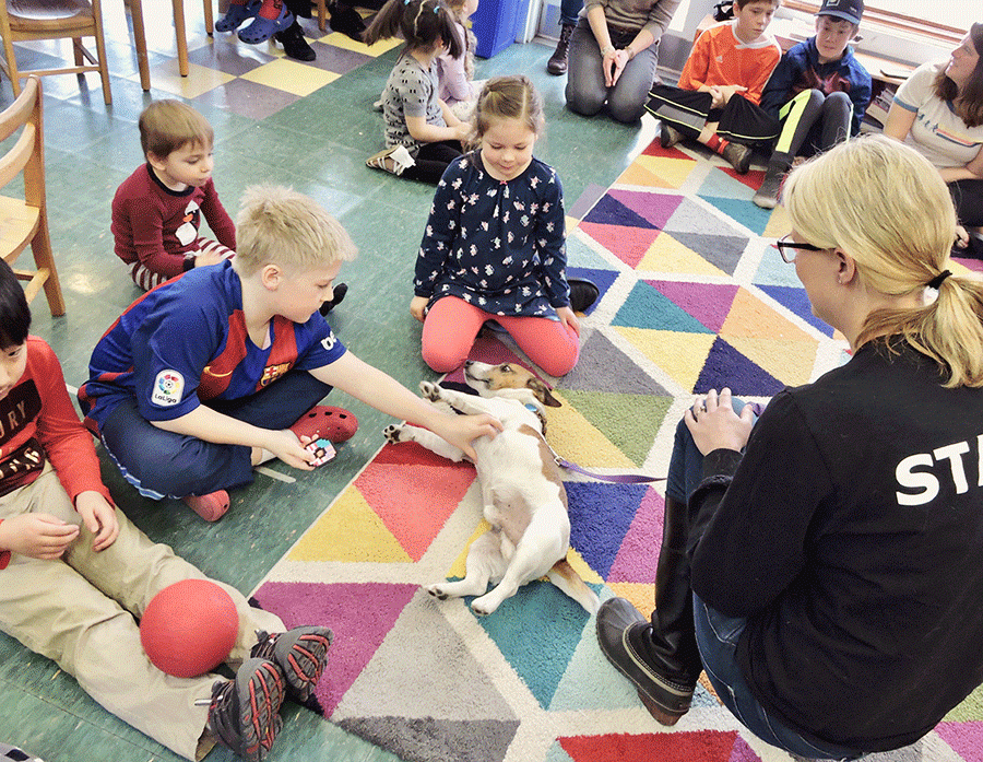 Student-puppy playtime at the Bellwether school in Williston