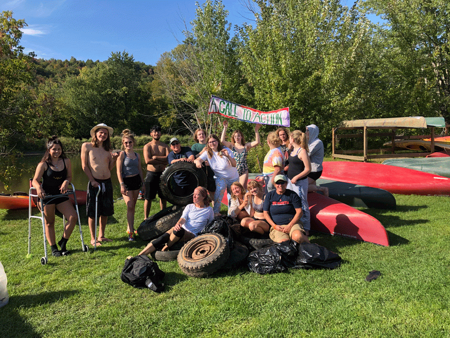 The+Call+to+Action+first-year+seminar+class+poses+with+the+8+tires+they+found+in+the+Lamoille+River.