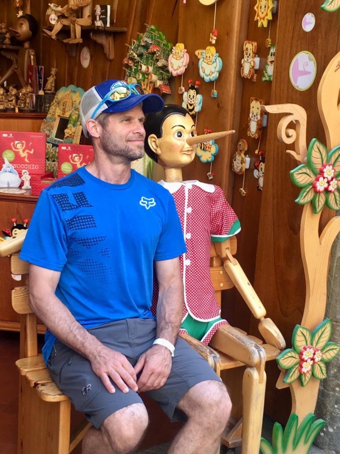 Brad Moskowitz sits with a wooden puppet on one of his many adventures