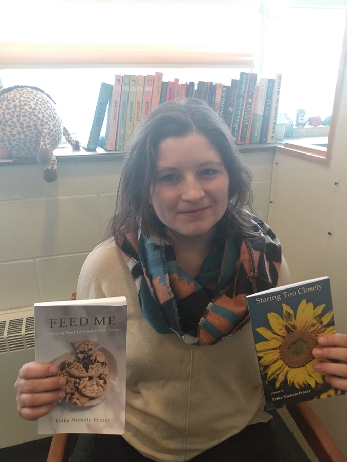 Erika Nichols-Frazer holding her books, Feed Me and Staring Too Closely