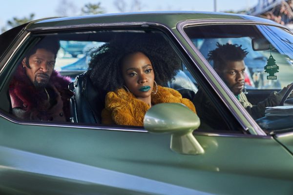 From left to right: Jamie Foxx as Slick, Teyonah Parris as Yo-yo, and John Boyega as Fontaine.