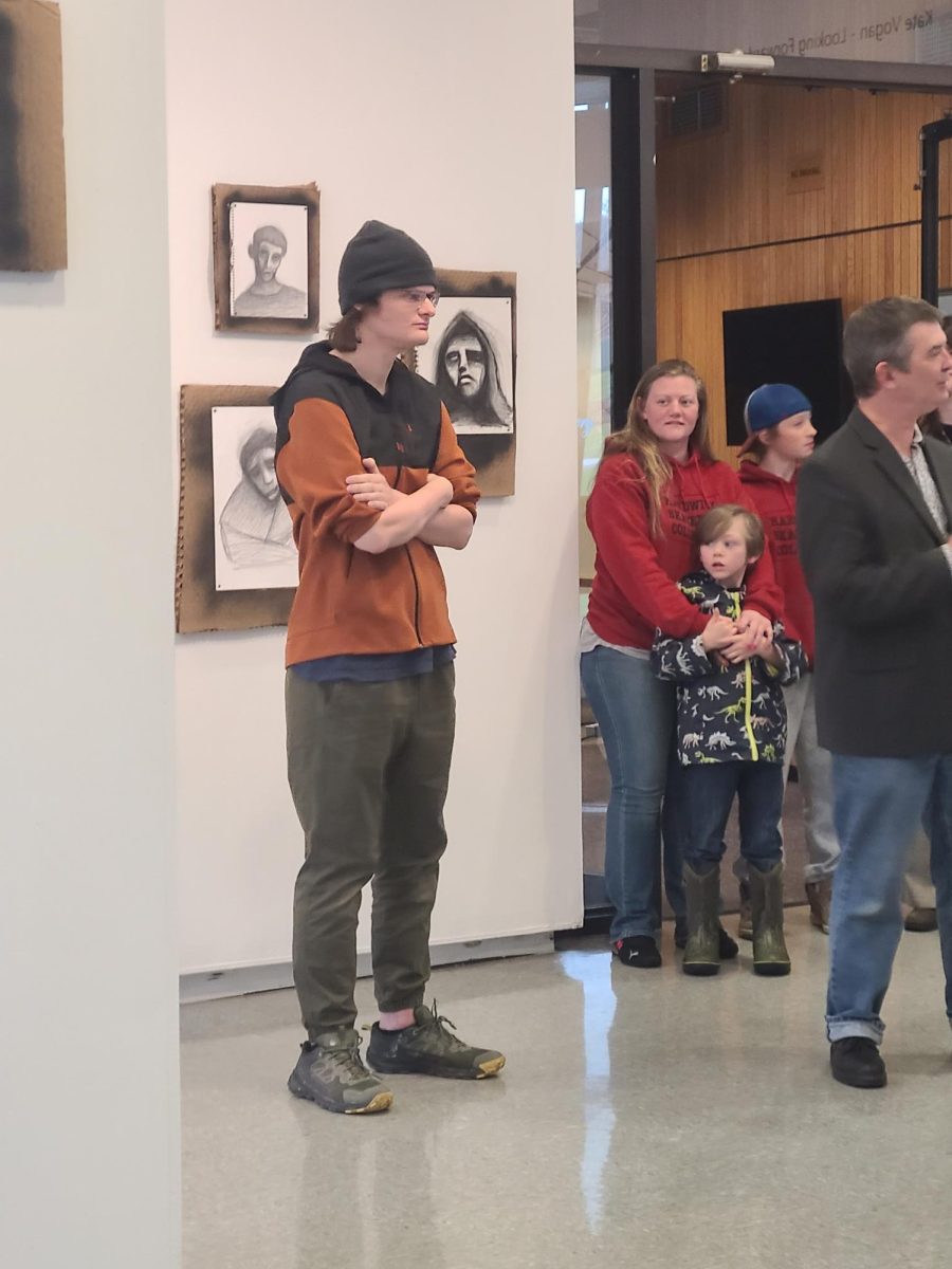 Owen Whitney standing in front of his work "Conscious Effort"
